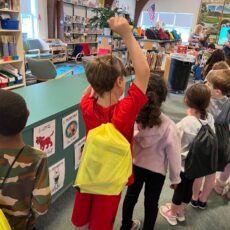 Students stand in line to receive their book bags